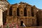 Tourist woman in hat looking at monastery Ad Deir. Tourism concept. Travel and tourism concept