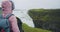 Tourist woman looking at Gullfoss waterfall the famous attraction and landmark destination on Iceland on the Golden