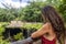 Tourist woman looking at the mouth of the subway cenote Saamal of chichen itza in the Mayan jungle hacienda of the Yucatan