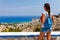 Tourist woman looking at sea landscape near Stegna and Archangelos on Rhodes island, Dodecanese, Greece. Panorama with mountains