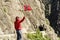 Tourist woman with norwegian flag in rocks mountains