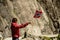 Tourist woman with norwegian flag in rocks mountains