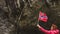 Tourist woman with norwegian flag in rocks mountains