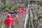 Tourist woman with norwegian flag in rocks mountains