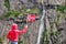 Tourist woman with norwegian flag in rocks mountains