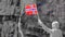 Tourist woman with norwegian flag in rocks mountains