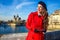 Tourist woman in Paris looking into distance and writing sms