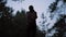 Tourist woman photographer hiking in forest