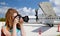 Tourist woman photographing by camera over plane