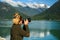 Tourist woman photographing the scenery at the beautiful shoreline in Bella Coola in British Columbia