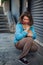 Tourist woman playing with red homeless cat