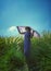 Tourist woman with purple shoulder clothes walking around in green grass flower garden with beautiful blue sky background.