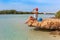 Tourist woman at the Red Sea coast and mangroves in the Ras Mohammed National Park. Famous travel destionation in desert. Sharm el