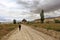 Tourist woman returns home on a dirt sandy road