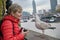Tourist woman with a seagull on the waterfront in London