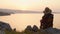 Tourist woman sit enjoy sunset panorama on viewpoint in persian gulf island