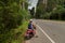 Tourist woman sitting on classic scooter against the background of the mountains of Krabi Province, Thailand.