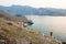 Tourist woman stand enjoy panorama on viewpoint in persian gulf Mirellas island. Musandam.Oman