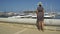 Tourist woman with straw sunhat Denia marina Port, Alicante, Spain