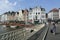 tourist woman with suitcase on grasbrug in centre of medieval Ghent in Belgium