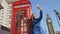 Tourist Woman on Taking Selfie Photo by Telephone booth and Big Ben in London