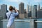 Tourist woman taking travel picture with camera of Manhattan Skyline and New York City skyline during autumn holidays.