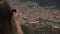 Tourist woman taking travel picture with camera, overview city Cuzco.View from the back.