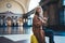 Tourist woman using  mobile phone on platform station in Barcelona. Girl traveler waiting train online gadget cellphone. Holiday