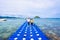 Tourist woman walk on floating dock