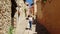 Tourist woman walking through a narrow alley in the medieval village of Anento in Zaragoza.