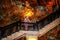 Tourist woman wearing a protective face mask stands on the stairs and looks up at the stalactites on the ceiling in Damlatas cave