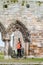 Tourist women observing the ruins of St Andrews