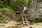 Tourist on wooden ladders in Slovak Paradise