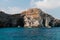 Tourist on yacht explore natural stone arches and caves. Malta