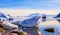 Touristic antarctic cruise ship among the icebergs