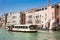 Touristic boat passing by the hands sculpture created by Spanish artist Lorenzo Quinn in the Venice Grand Canal to make an stateme