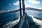 The touristic boat rushing through Lake Titicaca`s water with the Taquile Island on the horizon