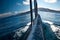 The touristic boat rushing through Lake Titicaca`s water with the Taquile Island on the horizon