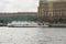 A touristic boat sailing on neva river near to the street edge of saint petersburg