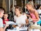 Touristic family relaxing in cafe looking map