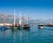 Touristic sailing boats stay in bay against mountains in Kemer