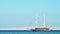 Touristic ship sailing Red Sea, extreme wide shot. Blue sky is clear. Photographed in Egypt in february. Selective soft