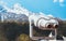 Touristic telescope look at the city with view snow mountains, closeup binocular on background viewpoint observe vision, metal