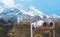 Touristic telescope look at the city with view snow mountains, closeup binocular on background viewpoint observe vision, metal