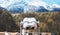 Touristic telescope look at the city with view snow mountains, metal binocular on background viewpoint observe vision, closeup