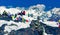 Tourists admire the beauty of mountain landscape and take pictures of Main Himalayan Range from top of Gokyo Ri peak