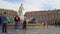 Tourists admiring Apollo statue crowning fountain at Place Massena, Nice