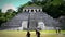 Tourists admiring Jaguar's Temple in the Palenque archeological zone.