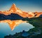 Tourists admiring nice view of Stellisee lake. Splendid evening scene of Matterhorn