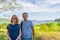 Tourists adult man and teenage girl posing against beautiful landscape in summer sunny day. Portraits of father and daughter on